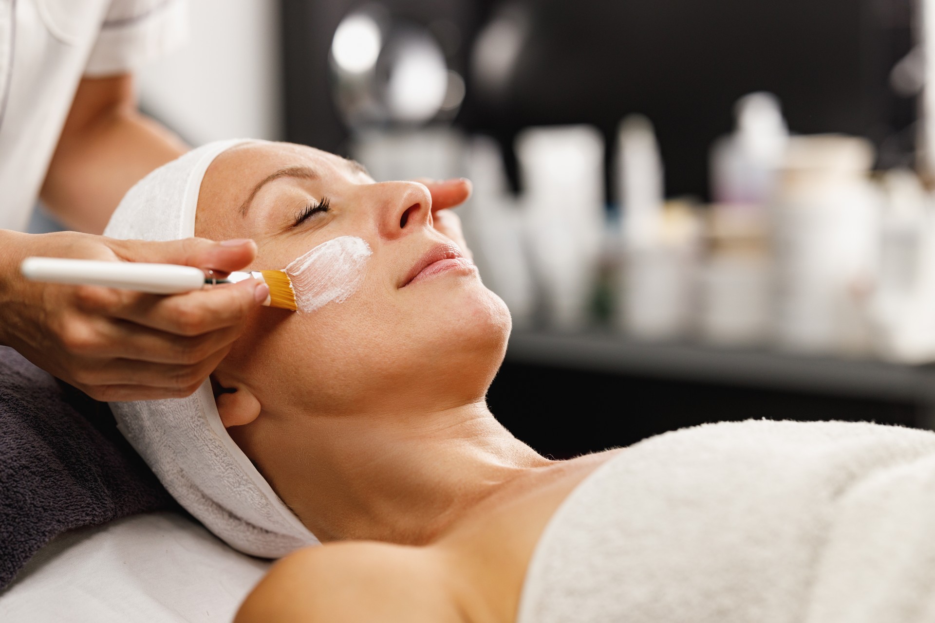 Woman Getting A Facial Mask Treatment At The Beauty Salon